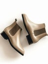 Taupe leather chelsea boots on white background.